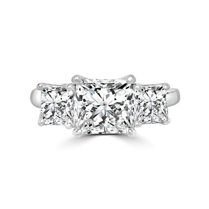 The DiamondVeneer Fashion Three Stone Square Diamond Veneer Cubic Zirconia 14K Gold Ring (635R009K) features a princess cut center stone and two side stones, all set in a sleek 14K white gold band.