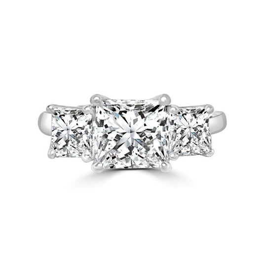 The DiamondVeneer Fashion Three Stone Square Diamond Veneer Cubic Zirconia 14K Gold Ring (635R009K) features a princess cut center stone and two side stones, all set in a sleek 14K white gold band.
