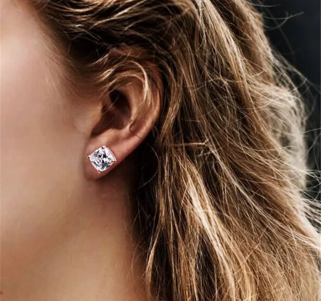 Cushion-cut cubic zirconia stud earrings in sterling silver, worn on model, 635E208